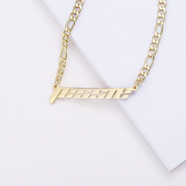 A gold-colored necklace with a personalized nameplate attached to it.