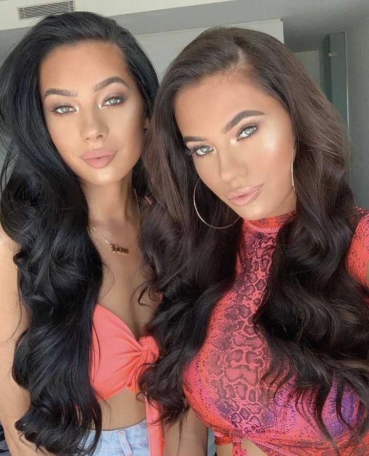 Two women with long, dark hair posing together for a photograph.