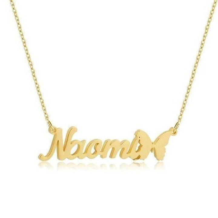 A gold-colored necklace with the name "Noah" engraved on it, along with a butterfly design.