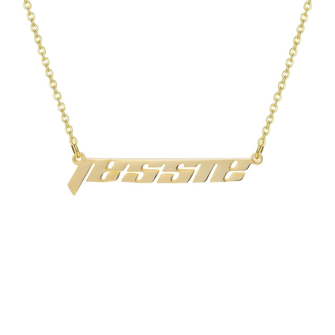 A gold necklace with the name "JESSIE" engraved on it.